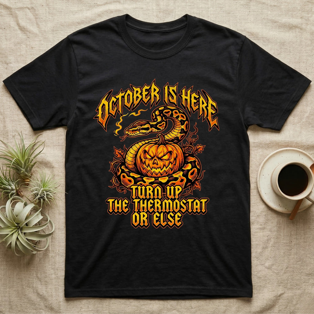 Ball Python October Thermostat T-Shirt in Black — Metal-band style ball python coiled over a glowing jack-o'-lantern, "October Is Here, Turn Up the Thermostat Or Else."