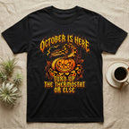 Ball Python October Thermostat T-Shirt in Black — Metal-band style ball python coiled over a glowing jack-o'-lantern, "October Is Here, Turn Up the Thermostat Or Else."