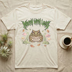 Pacman Frog Feral T-Shirt in Natural — Round Pacman frog in a pastel forest-floor scene under a spiky leaf-green metal wordmark reading MOUTH WITH LEGS.