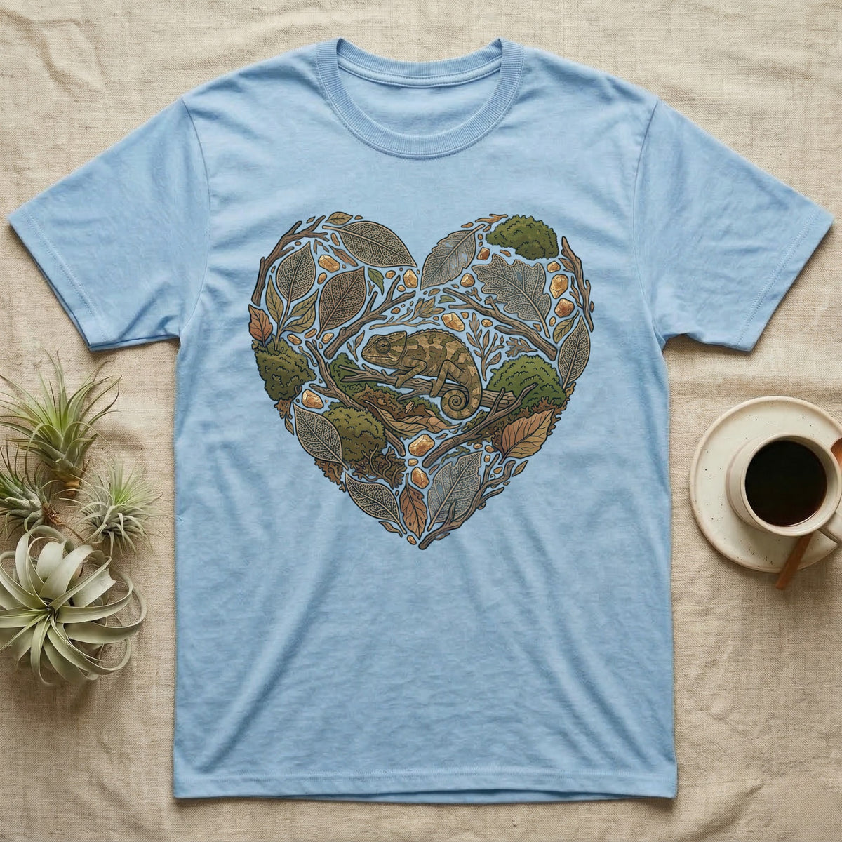 Light blue t-shirt featuring a heart-shaped design with a chameleon and foliage.