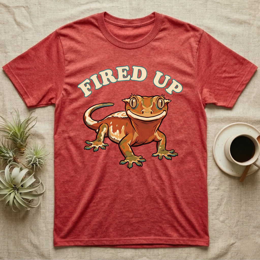 Fired Up Crested Gecko T-Shirt in Heather Red — Retro 90s-style illustration of a fired-up crested gecko under a bold arc headline reading Fired Up.
