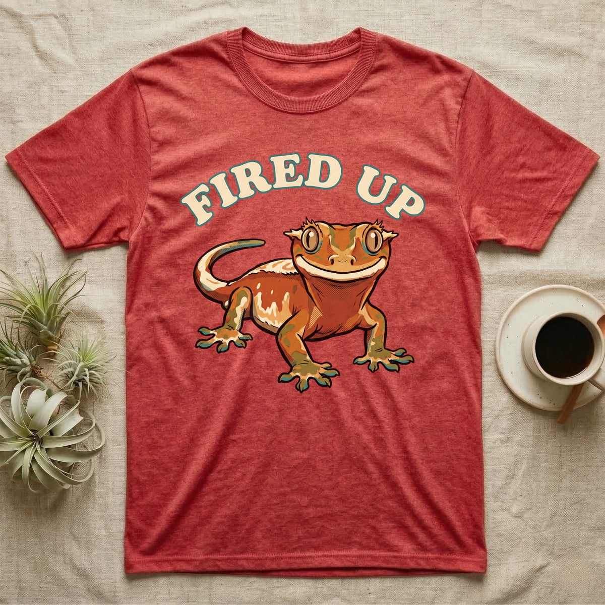 Fired Up Crested Gecko T-Shirt in Heather Red — Retro 90s-style illustration of a fired-up crested gecko under a bold arc headline reading Fired Up.