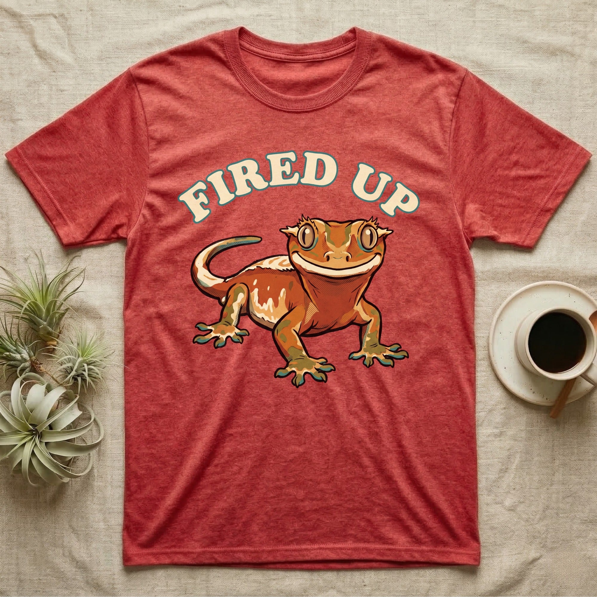 Fired Up Crested Gecko T-Shirt in Heather Red — Retro 90s-style illustration of a fired-up crested gecko under a bold arc headline reading Fired Up.