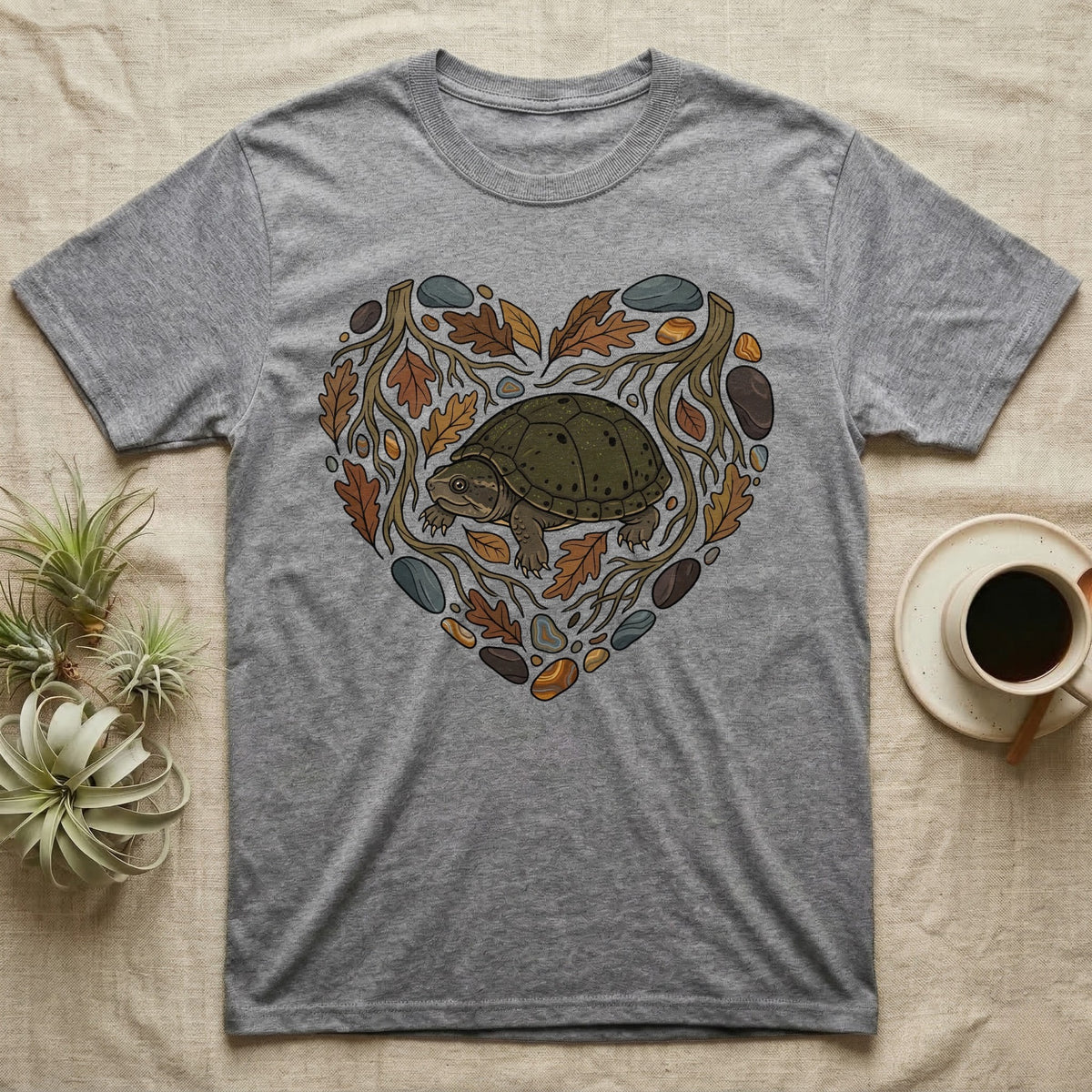 Grey t-shirt with a heart-shaped natural design featuring a turtle and leaves.
