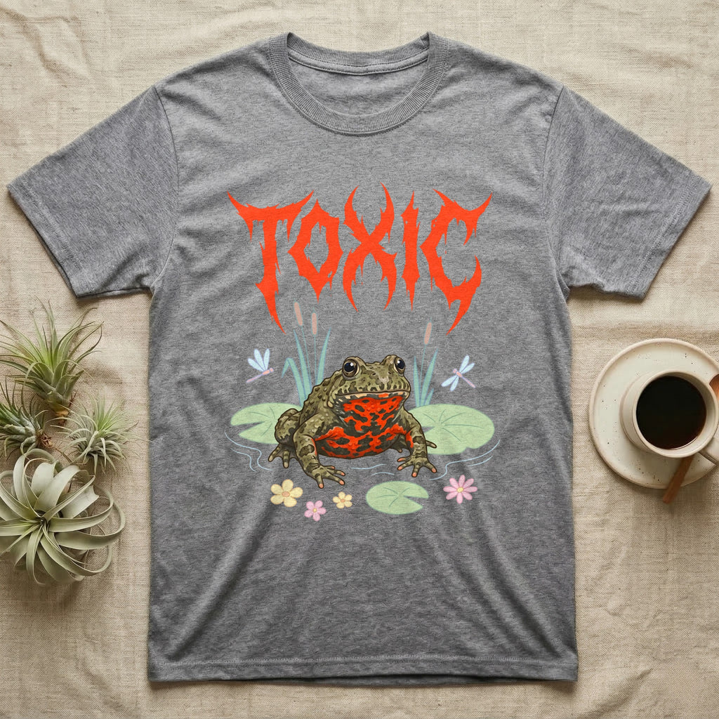 Oriental Fire-Bellied Toad Feral T-Shirt in Sport Grey — Pastel fire-bellied toad with red-orange belly among lily pads and dragonflies, jagged metal wordmark "TOXIC" above.