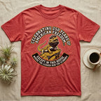 Bearded Dragon 1776 T-Shirt in Heather Red — Bold woodcut tee of a bearded dragon in a tricorn hat black-bearding on a rock, gold and cream banner reading the lizards run the economy.