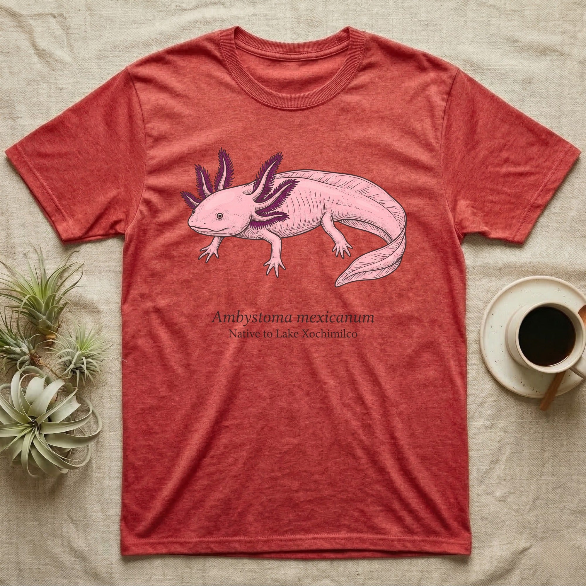 Red t-shirt with illustration of a pink axolotl and text "Ambystoma Mexicanum Native to Lake Xochimilco".