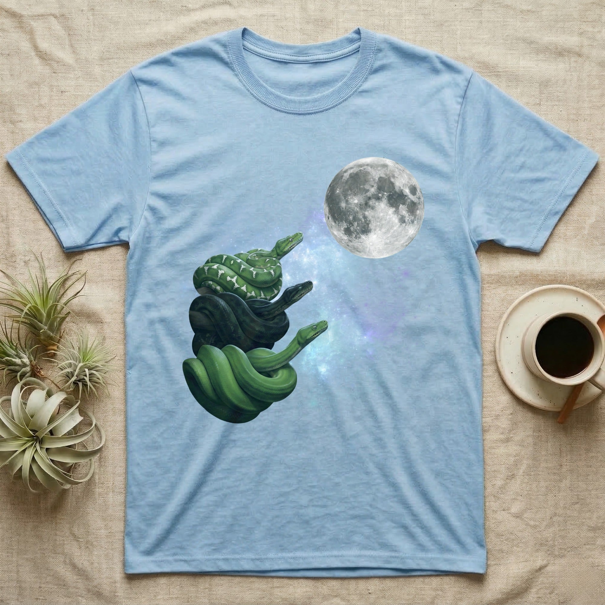 Emerald Tree Boa Moon Howl T-Shirt in Light Blue — Three Emerald Tree Boa colour morphs howling at a full moon over a nebula on a dark grey t-shirt.