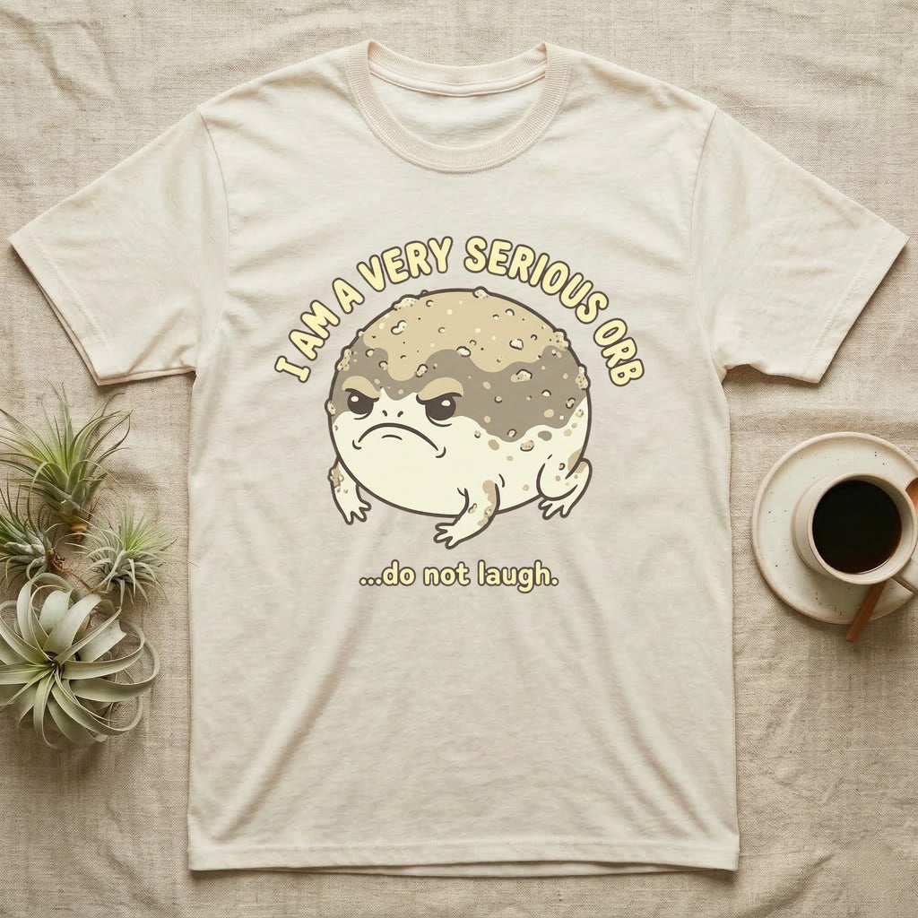 Cream t-shirt with grumpy toad and "I am a very serious orb...do not laugh" text.