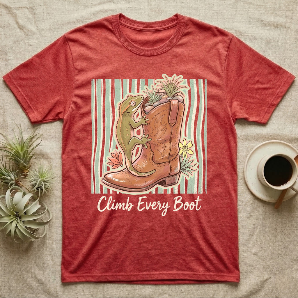 Red t-shirt with a cowboy boot, gecko, and flowers, text "Climb Every Boot".