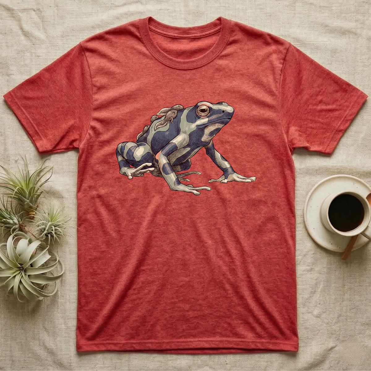 Dart Frog Tadpole T-Shirt in Heather Red — Naturalist-plate illustration of a dyeing dart frog carrying tadpoles on its back with a dry typewriter caption beside it.