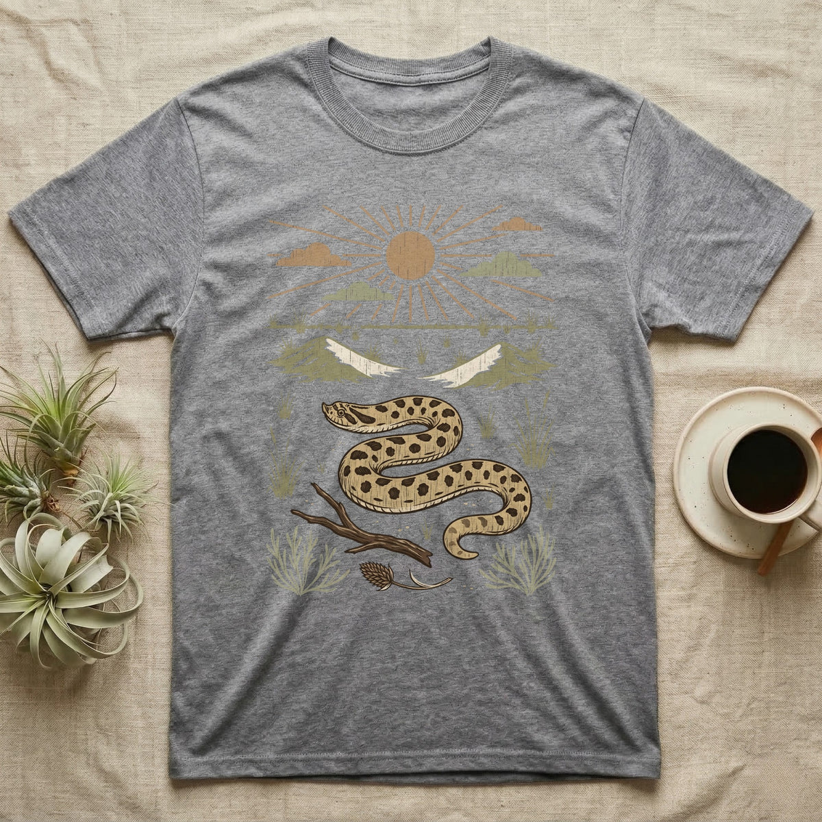 Western Hognose Home Range T-Shirt in Sport Grey — Woodcut-style illustration of a western hognose snake nosing through sand with dunes and sagebrush behind, no on-shirt text.