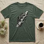 Dark green t-shirt with black lizard graphic on a tree branch.
