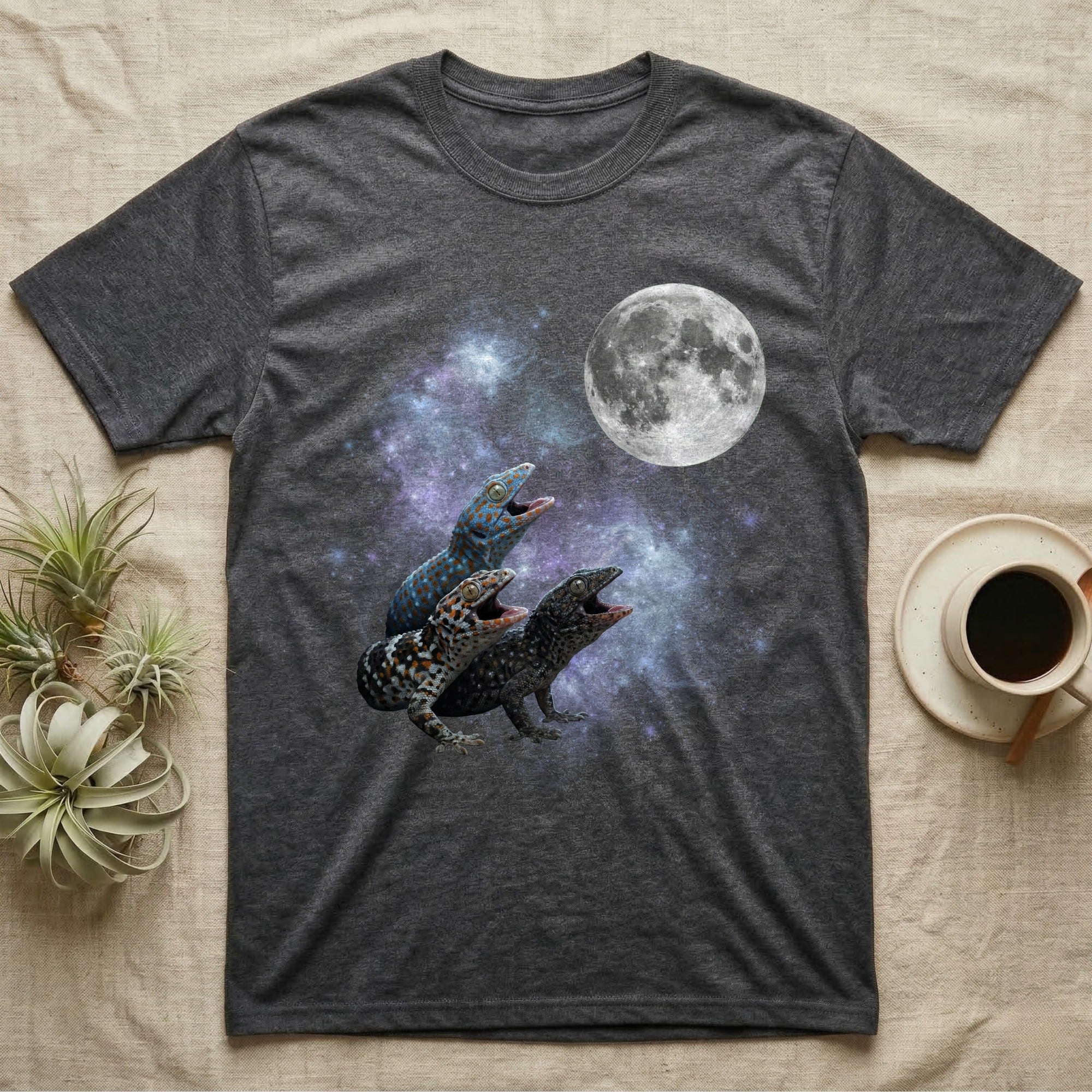 Tokay Gecko Moon Howl T-Shirt in Dark Heather — Three Tokay Gecko colour morphs howling at a full moon over a nebula on a dark grey t-shirt.
