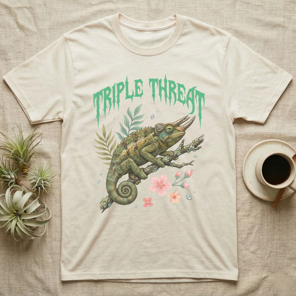 Jackson's Chameleon Feral T-Shirt in Natural — Three-horned Jackson's chameleon on a branch below a dripping jade-green metal "Triple Threat" wordmark