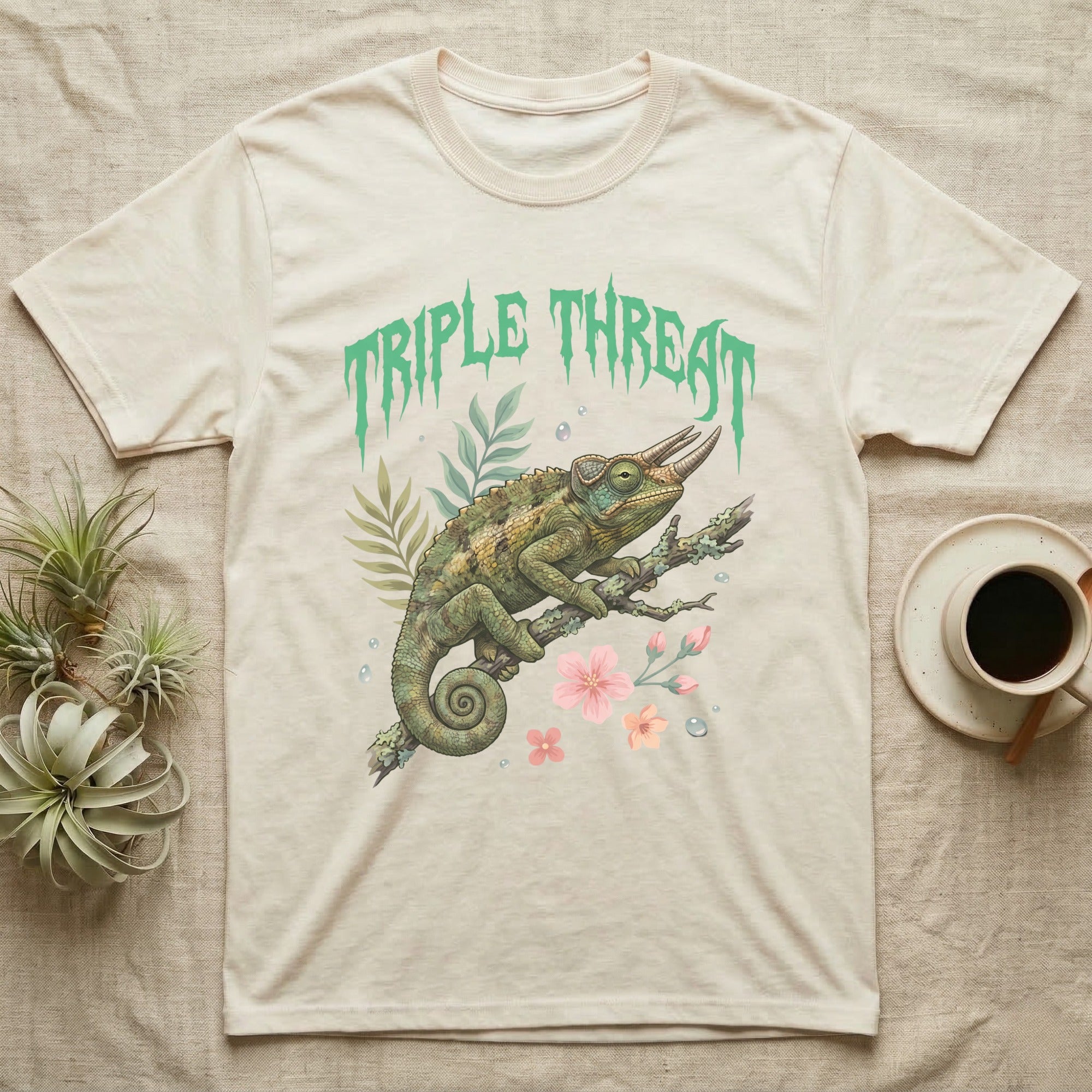 Jackson's Chameleon Feral T-Shirt in Natural — Three-horned Jackson's chameleon on a branch below a dripping jade-green metal "Triple Threat" wordmark