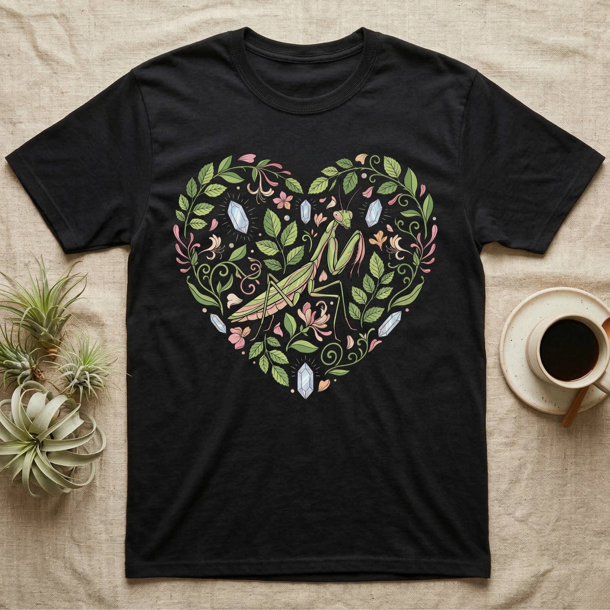 Black t-shirt with a heart-shaped floral design featuring a praying mantis.