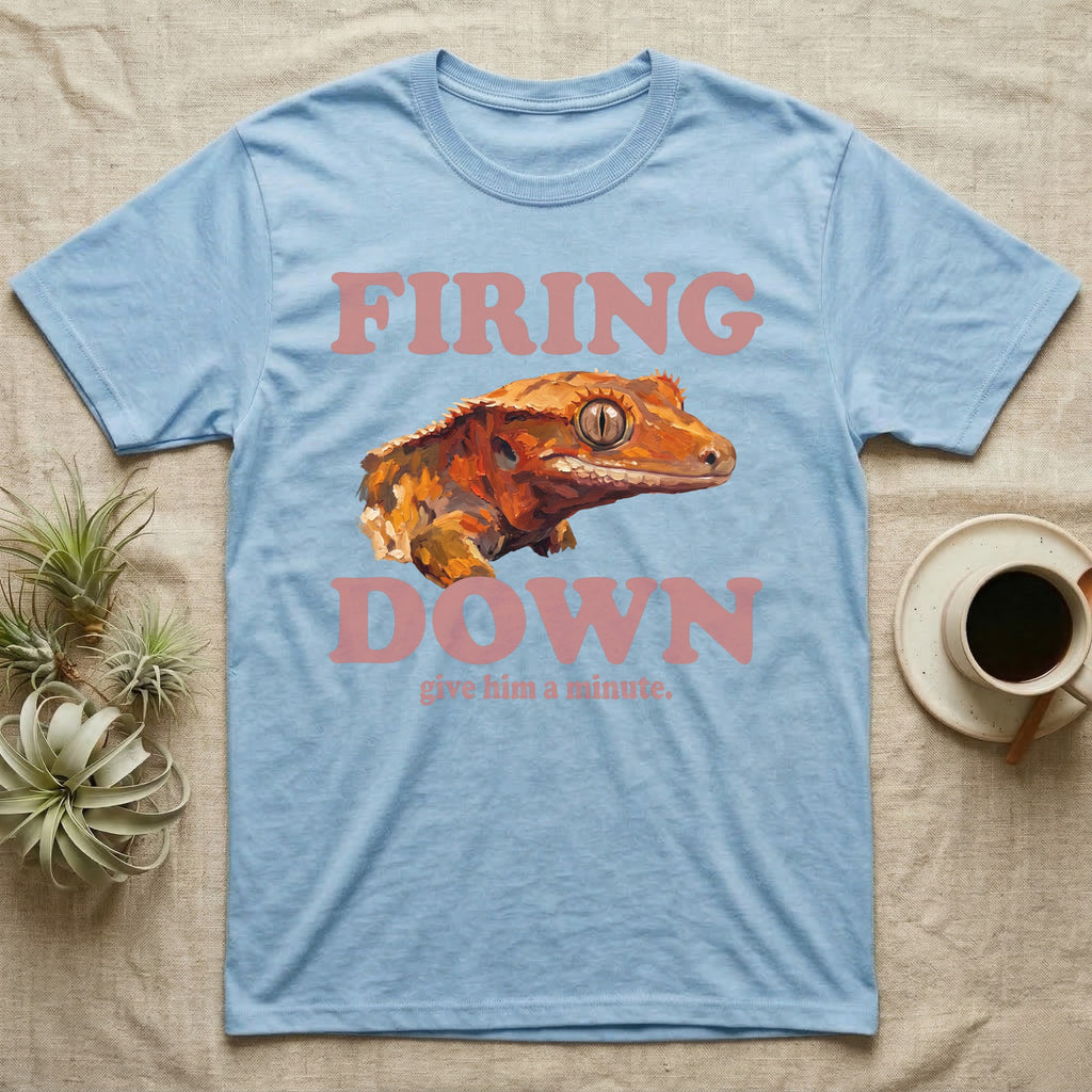 Crested Gecko Firing Down T-Shirt in Light Blue — Engraved crested gecko in navy ink between the rose words Firing and Down, with give him a minute above.