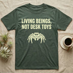 Living Beings Spider T-Shirt in Military Green — Bold typographic broadside reading Living Beings Not Desk Toys above a small front-facing jumping spider silhouette.