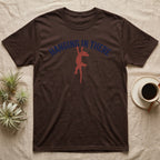 Crested Gecko Hanging T-Shirt in Dark Chocolate — Red crested gecko hanging by its front feet from the navy arched words HANGING IN THERE