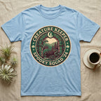 Creature Keeper Spooky Squad T-Shirt in Light Blue — Embroidered-patch badge with a gecko, chameleon, snake and tarantula in a stone archway, "Creature Keeper Spooky Squad."