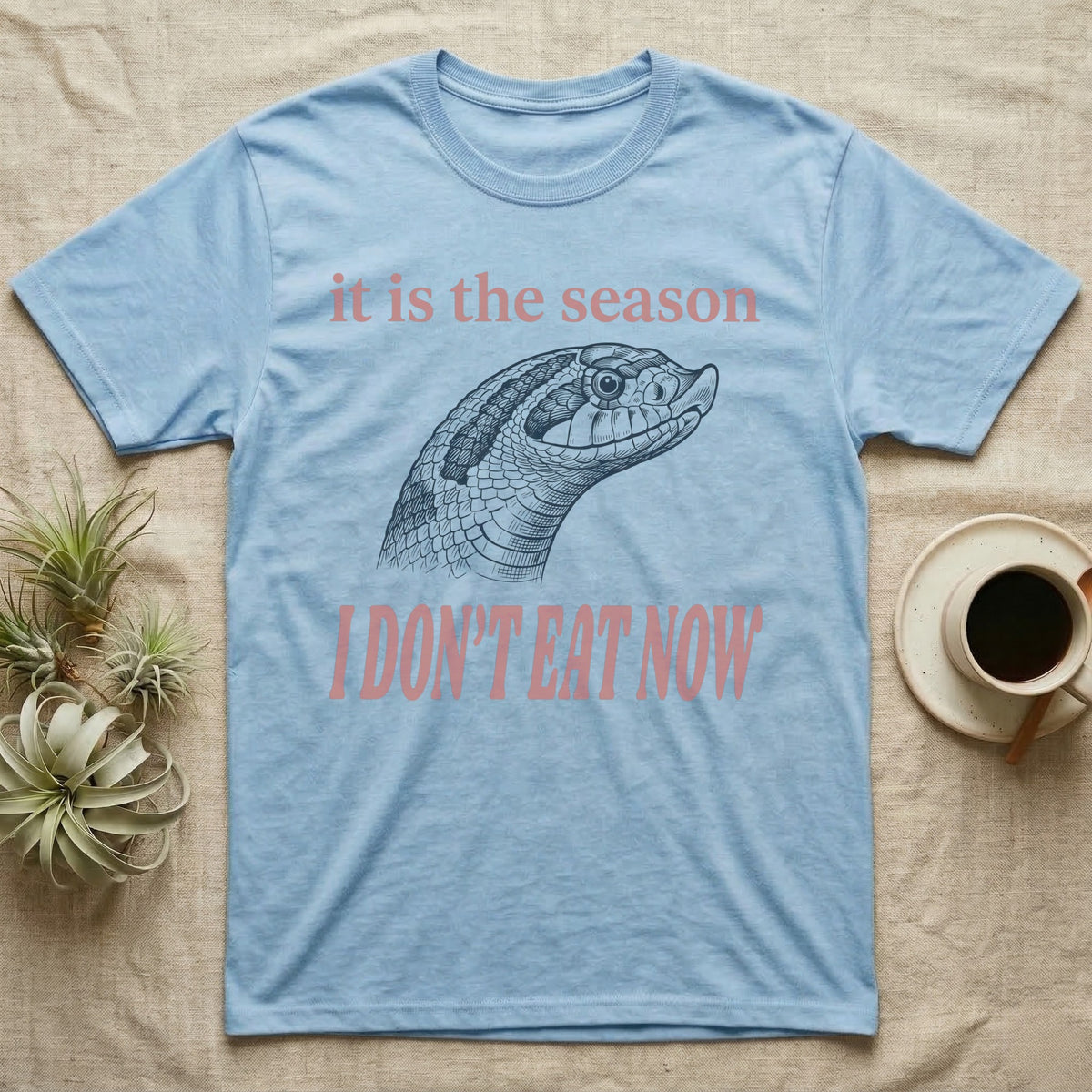 Hognose Fasting Season T-Shirt in Light Blue — Engraved western hognose snake head in profile, snout raised, under large retro lettering reading I DON'T EAT NOW.