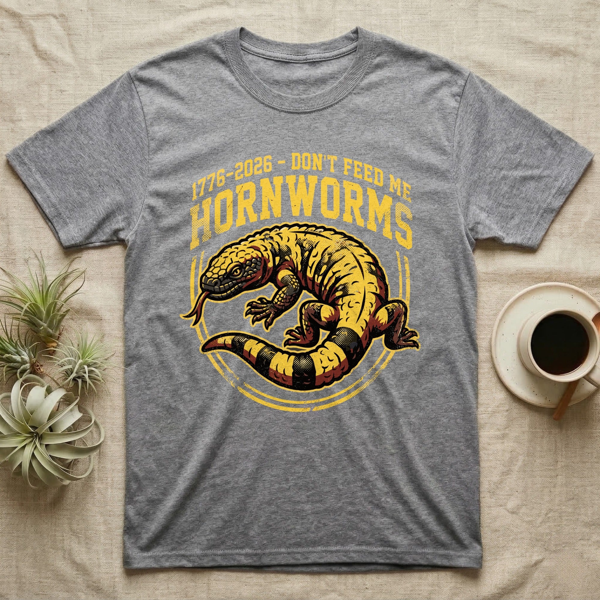 Gila Monster Hornworms Tee in Sport Grey — Bold gold and maroon woodcut tee of a Gila monster with banded tail, large text reading Don't Feed Me Hornworms, on black.