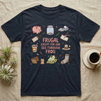Glass Frog Frugal T-Shirt in Navy — Cartoon glass frog on a leaf under the words Frugal except for one see-through frog, ringed by a piggy bank, coin jar, coupons and other thrifty things