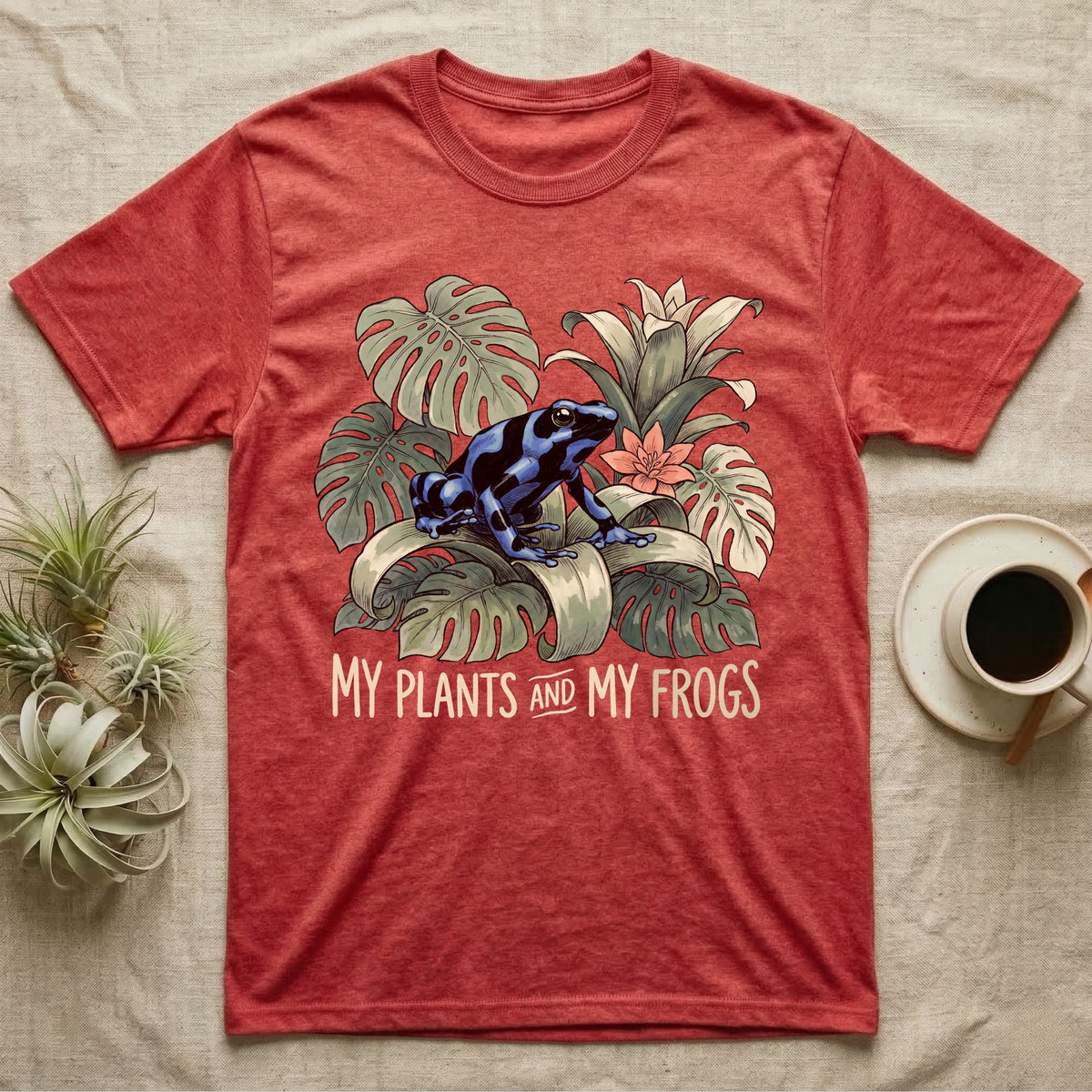 Plants And Frogs T-Shirt in Heather Red — Naturalist-plate illustration of a dart frog perched in lush foliage with hand-lettered text reading My Plants And My Frogs.