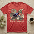 Plants And Frogs T-Shirt in Heather Red — Naturalist-plate illustration of a dart frog perched in lush foliage with hand-lettered text reading My Plants And My Frogs.