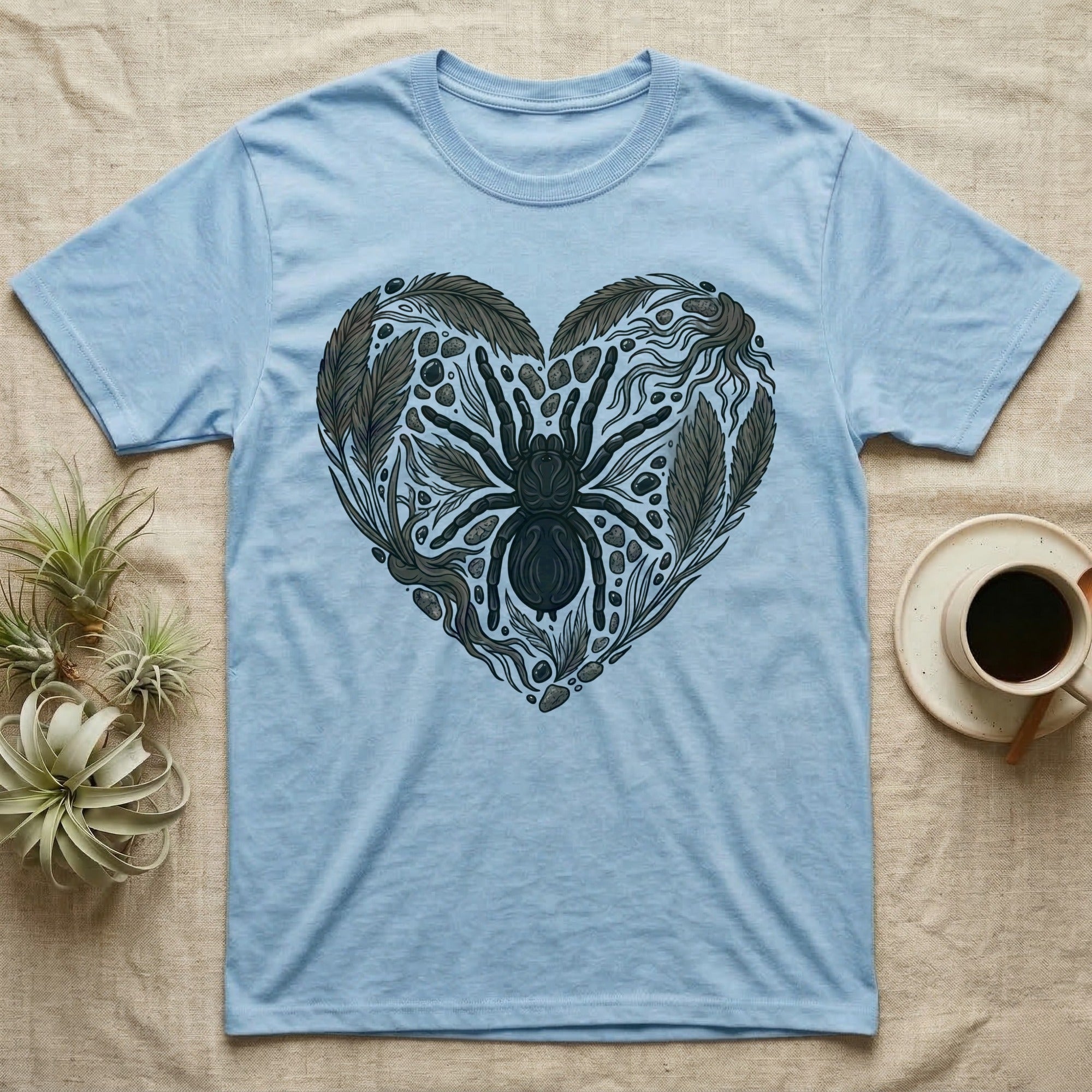 Light blue t-shirt with a black spider and leafy heart design.