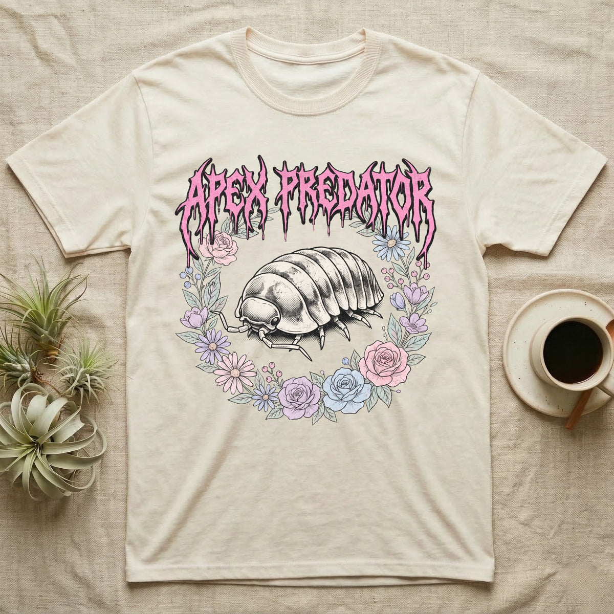 Apex Predator Isopod T-Shirt in Natural — Bootleg design of a cute isopod in a floral wreath under dripping death-metal lettering reading "Apex Predator."