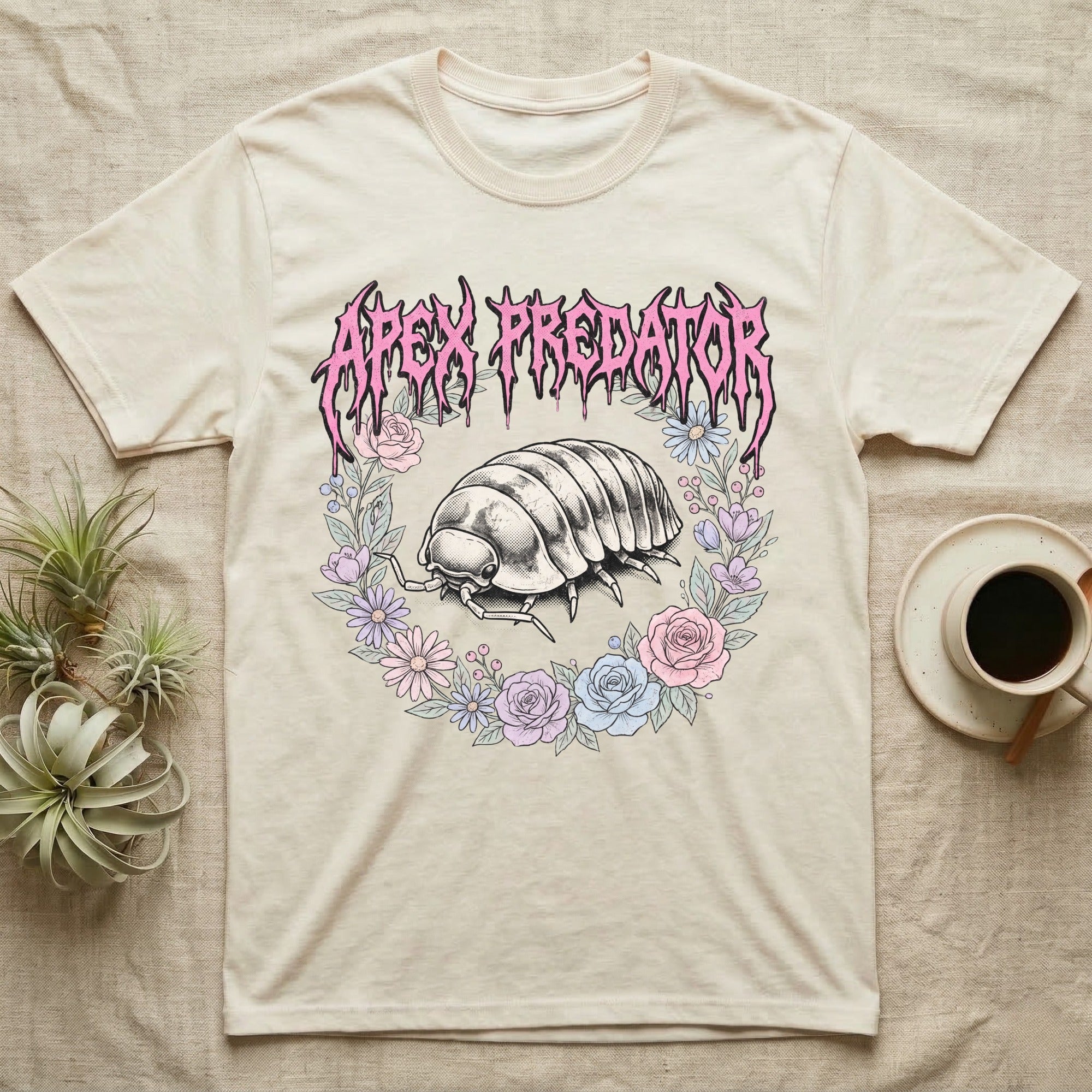 Apex Predator Isopod T-Shirt in Natural — Bootleg design of a cute isopod in a floral wreath under dripping death-metal lettering reading "Apex Predator."