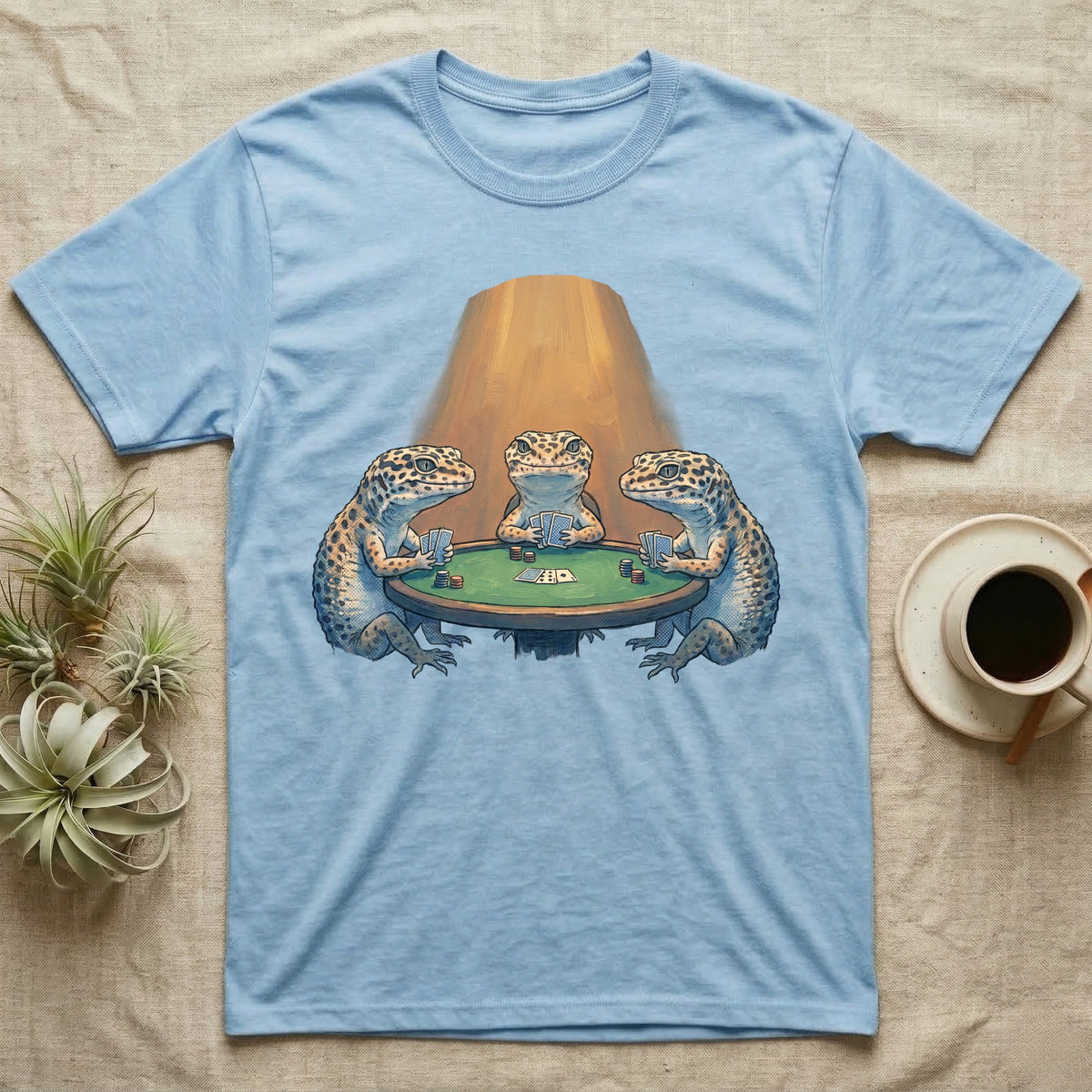 Leopard Gecko Poker T-Shirt in Light Blue — Vintage oil-painting tableau of three leopard geckos playing poker around a green-felt table in warm amber light.