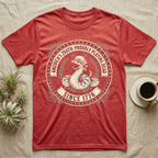 Hognose Snake 1776 Tee in Heather Red — Vintage circular seal of a hognose snake playing dead belly-up in a colonial wig, brick-red and cream emblem reading Proudly Playing Dead Since 1776.