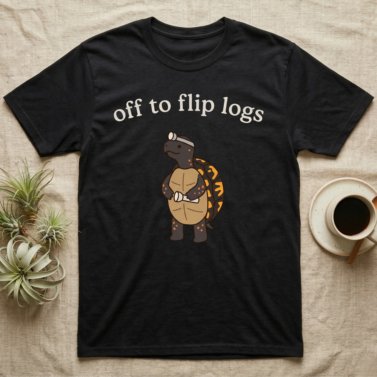 Box Turtle Herping T-Shirt in Black — Minimal doodle of an eastern box turtle standing upright in a headlamp holding a flashlight, under the words off to flip logs
