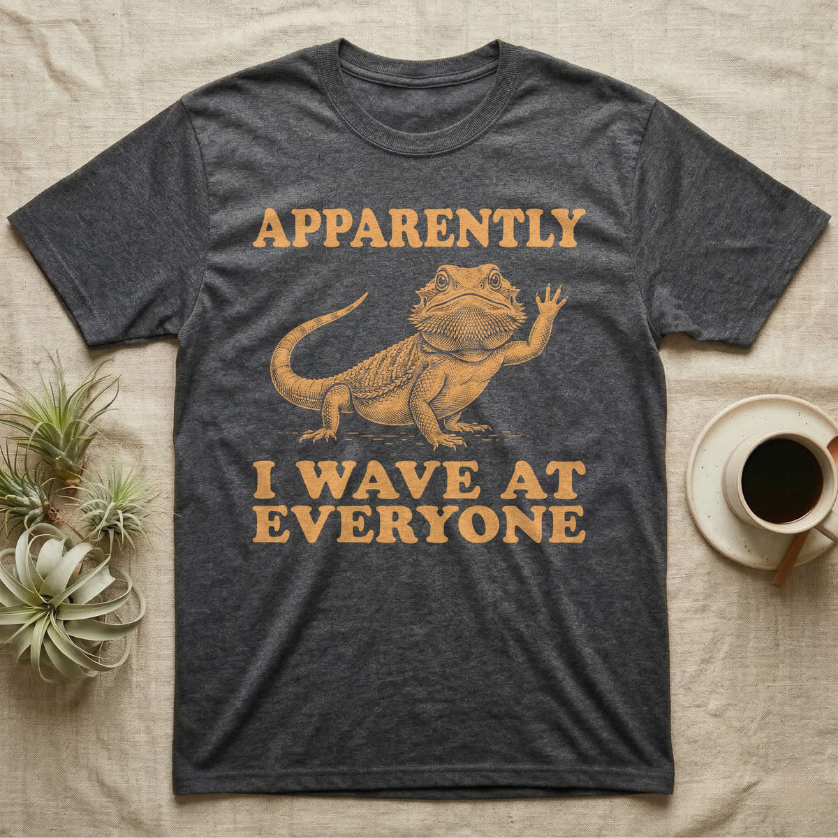Bearded Dragon Engraving T-Shirt in Dark Heather — Antique green engraving of a bearded dragon raising one arm between the words APPARENTLY and I WAVE AT EVERYONE