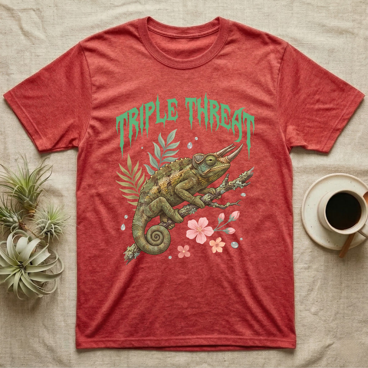Jackson's Chameleon Feral T-Shirt in Heather Red — Three-horned Jackson's chameleon on a branch below a dripping jade-green metal "Triple Threat" wordmark