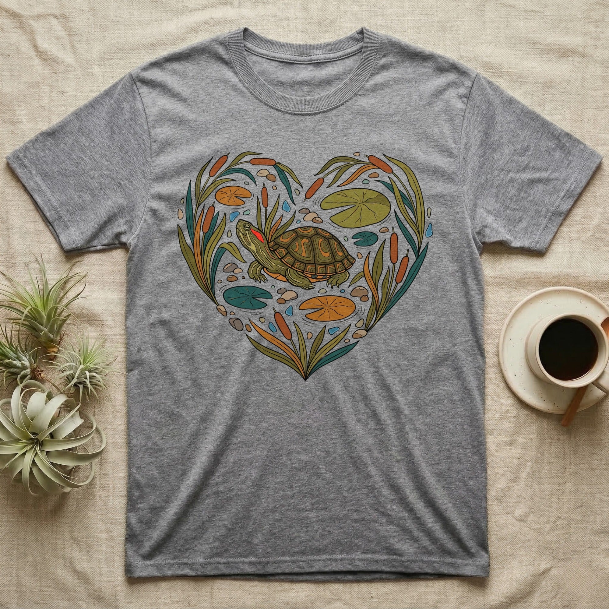 Gray t-shirt with a heart-shaped illustration of a turtle and pond plants.