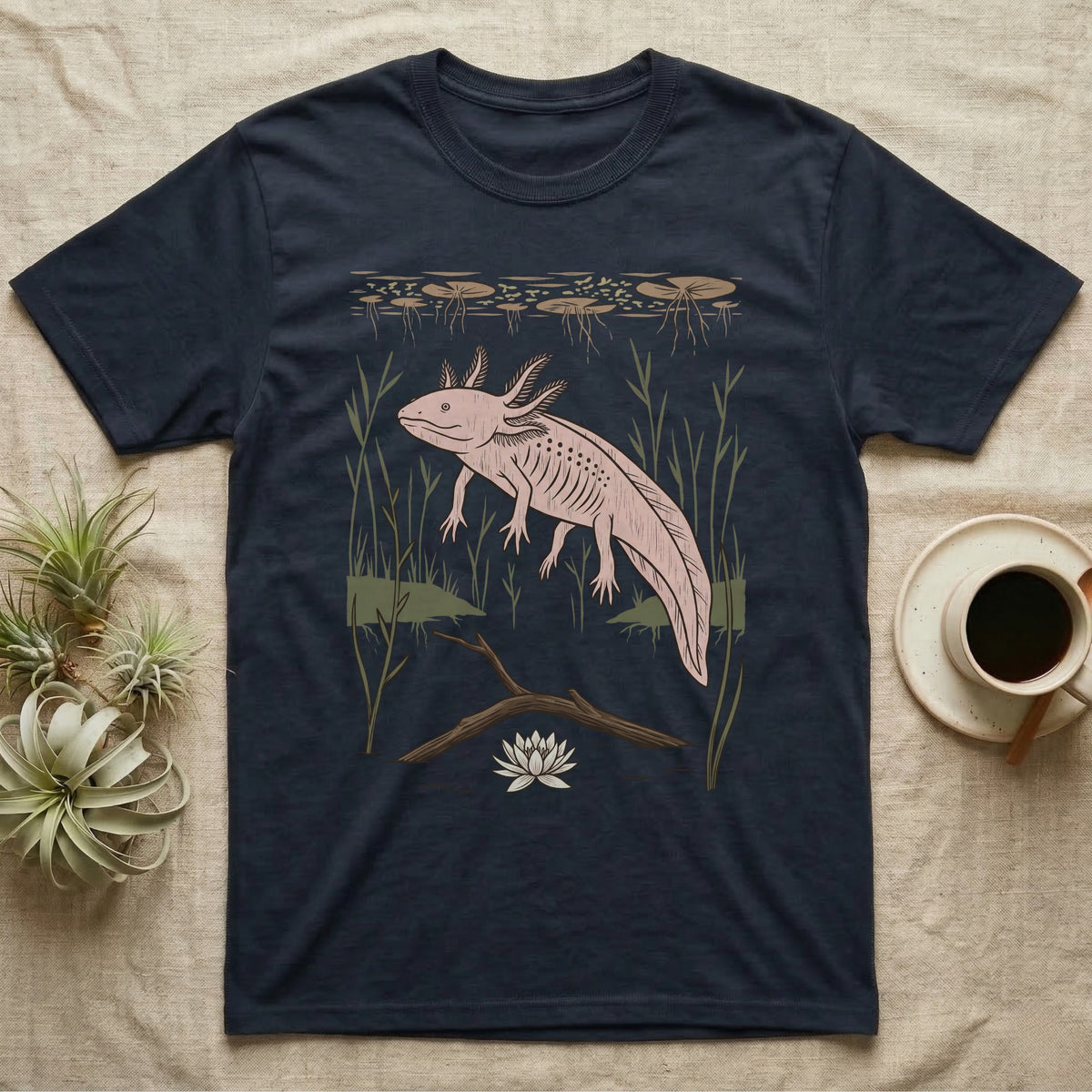 Axolotl Home Range T-Shirt in Navy — Woodcut-style illustration of an axolotl drifting among reeds and lily pads in a Xochimilco canal, no on-shirt text.