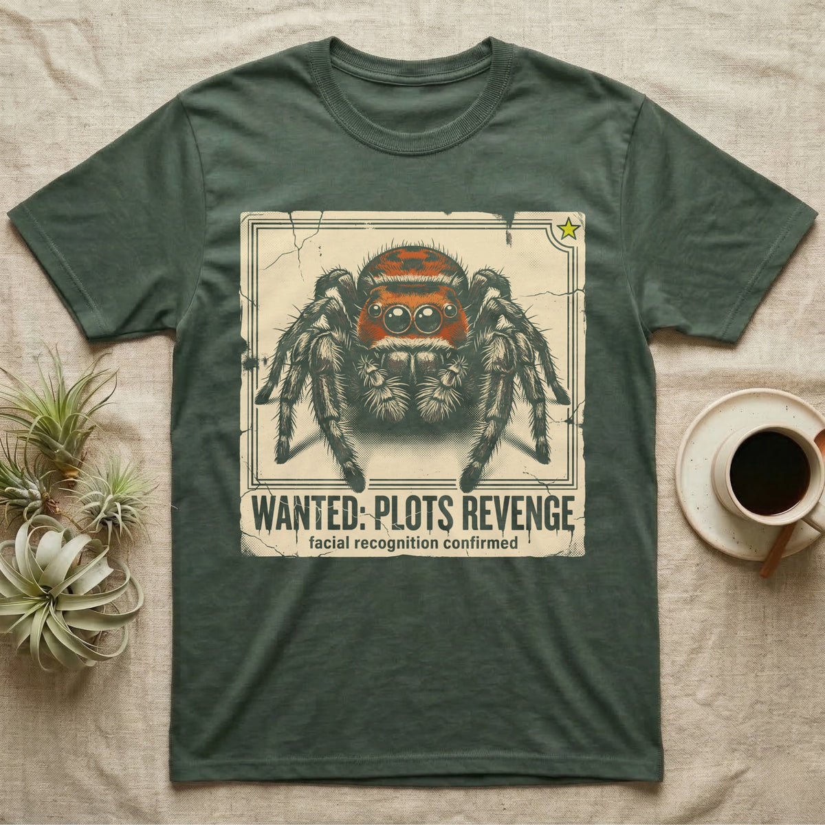 Jumping Spider Wanted T-Shirt in Military Green — Distressed wanted-poster illustration of a front-facing jumping spider with the banner text plots revenge below.