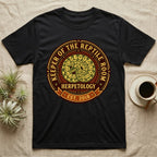 Black t-shirt with "Keeper of the Reptile Room Est. 2018" and snake graphic.