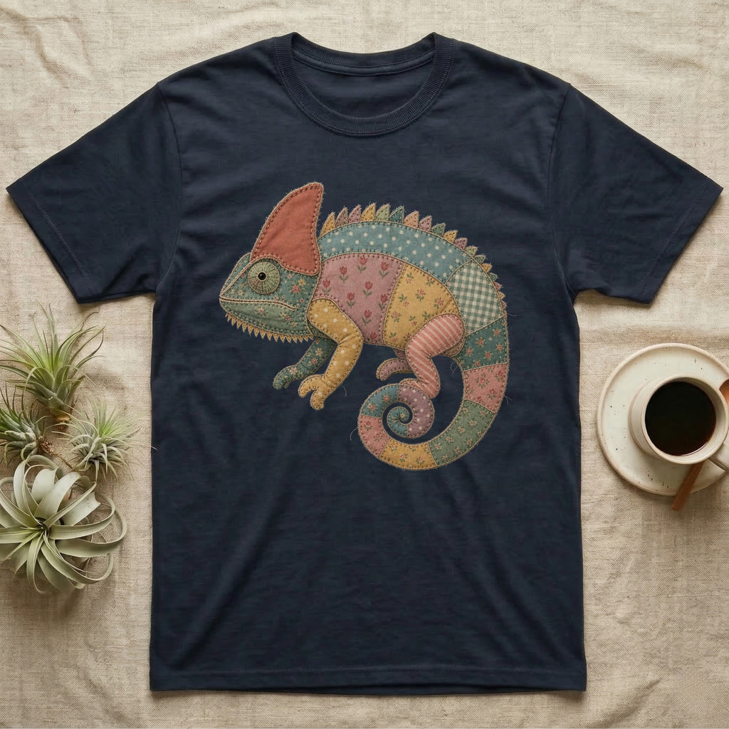 T-shirt with a colorful patchwork chameleon graphic on a dark blue background.