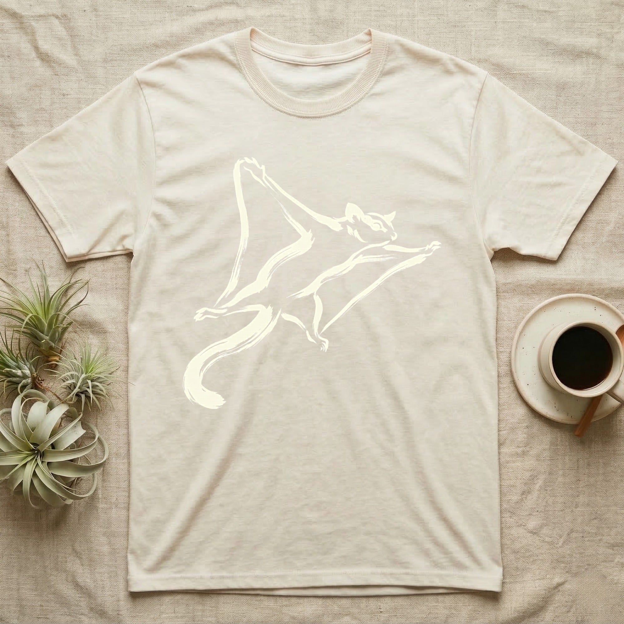 Cream t-shirt with a cream-colored flying squirrel graphic.
