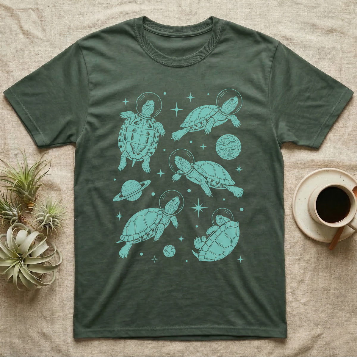 Red Eared Slider Cosmic T-Shirt in Military Green — Vintage screen-print illustration of red-eared slider turtles in astronaut helmets floating in space, cosmic teal monochromatic on dark background.