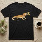 Bearded Dragon Blossom T-Shirt in Black — Watercolor illustration of an ochre bearded dragon holding a golden wattle blossom sprig, on a dark grey t-shirt.