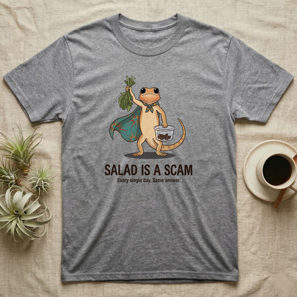 Bearded Dragon Salad Scam T-Shirt in Sport Grey — Storybook-cartoon bearded dragon holding wilted greens at arm's length and a tub of roaches, captioned "Salad Is a Scam".