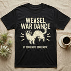 Weasel War Dance Ferret Tee in Black — Grunge-distressed ferret mid-war-dance in S-curve bounce with stacked type "Weasel War Dance / If You Know."