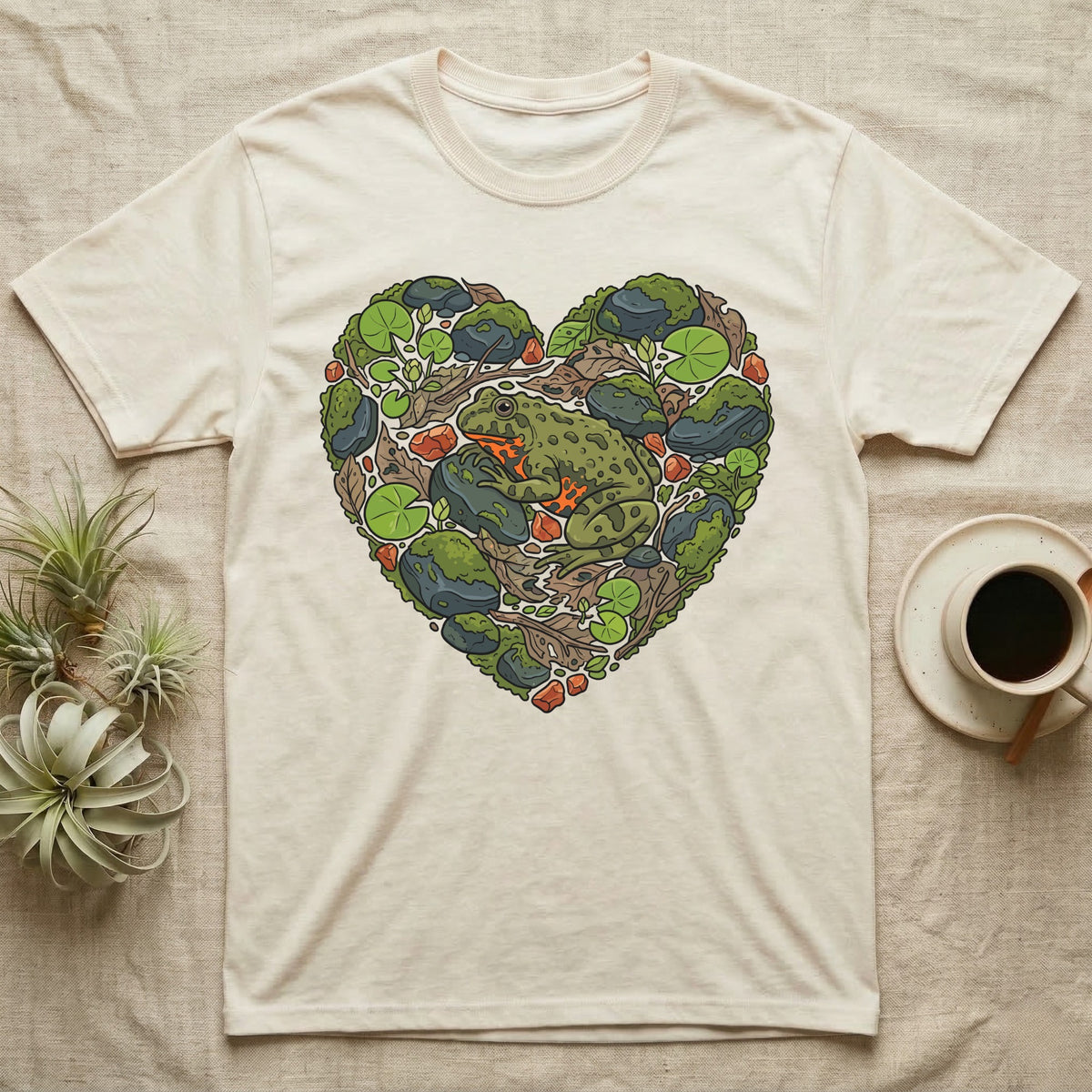 Cream t-shirt with a heart-shaped design of a frog and natural elements.