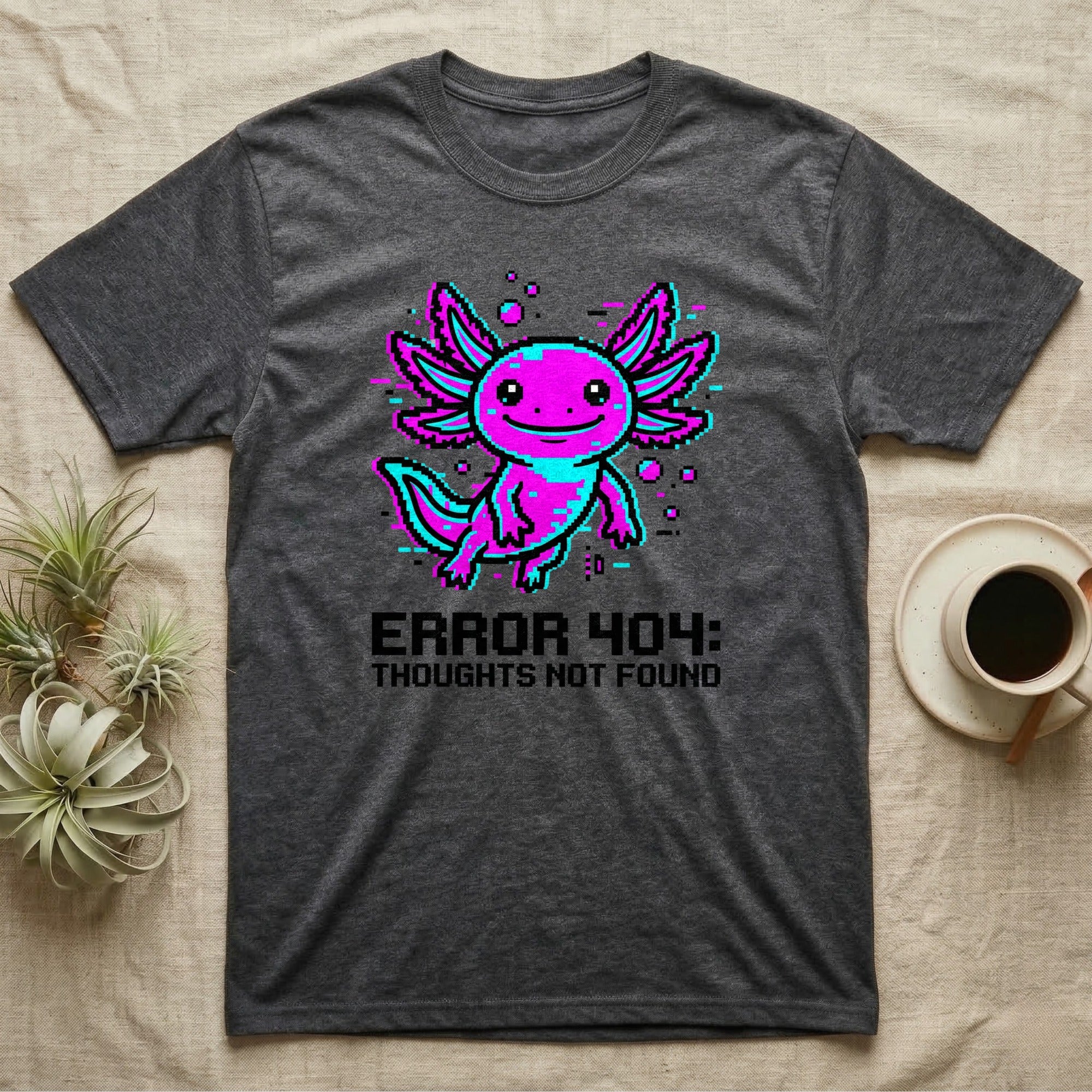 Dark gray t-shirt with pixelated axolotl and "ERROR 404: THOUGHTS NOT FOUND" text.